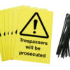 trespassers will be prosecuted signs pre-drilled holes with 24 cable ties. yellow background with black text and symbol