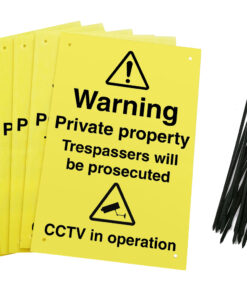 Warning private property trespassers will be prosecuted CCTV in operation signs with drilled holes and cable ties. yellow background with black text and symbols